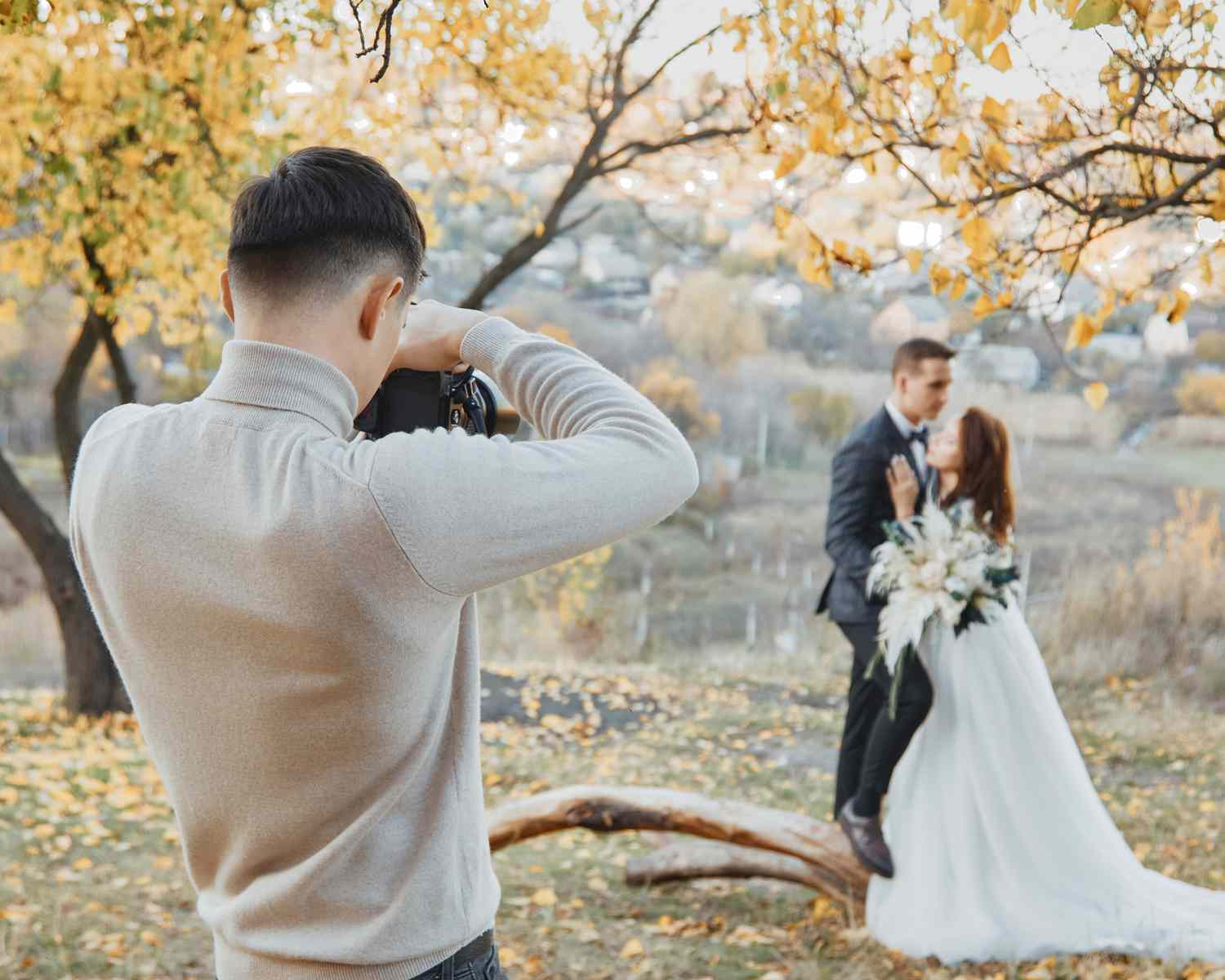 Wedding photographer capturing a couple at golden hour